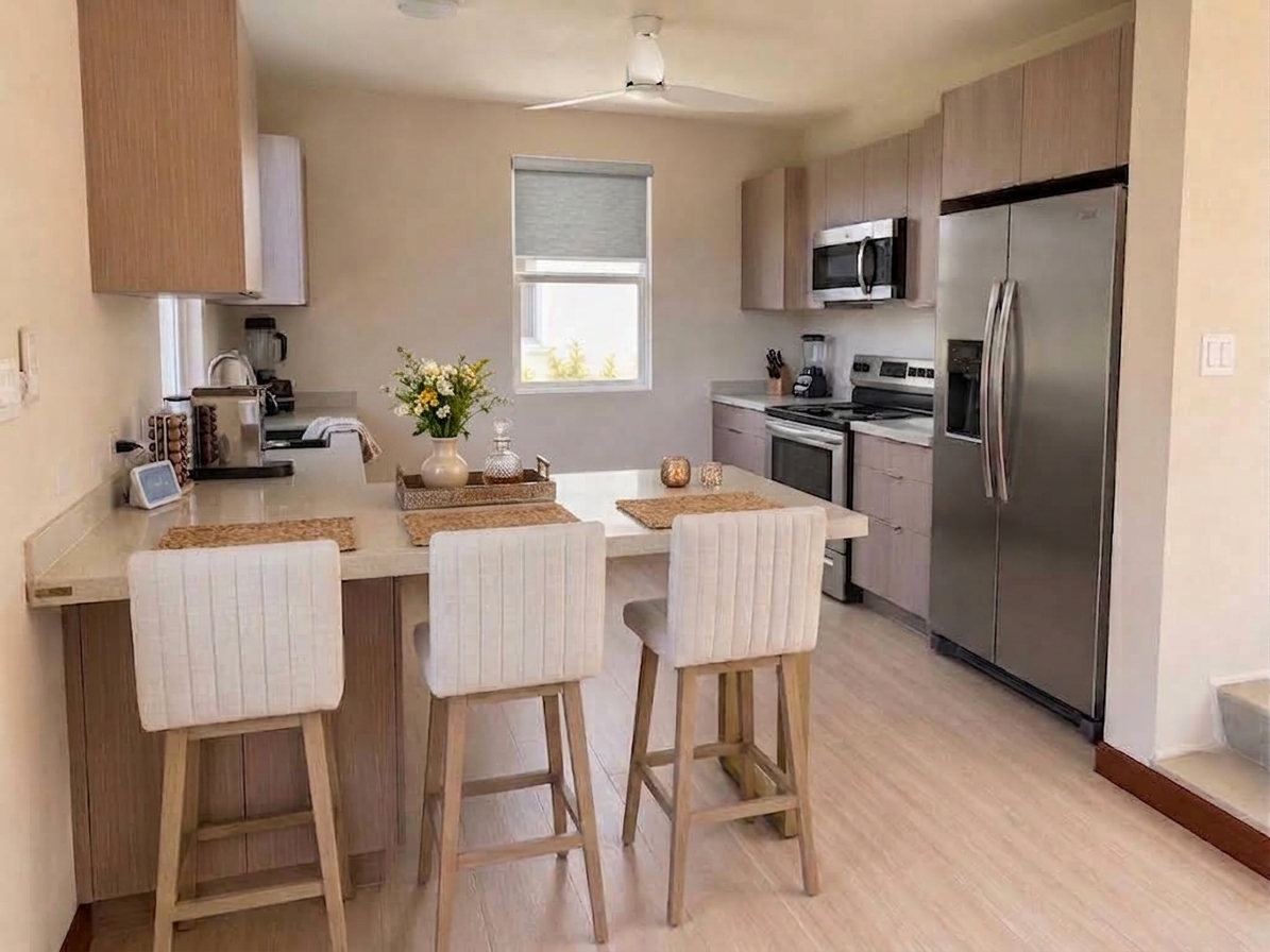 The kitchen with a five-burner range, full-size fridge and light oak cabinetry.